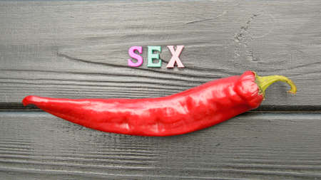 Red hot chilly juicy pepper on a dark background