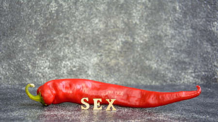 Red hot chilly juicy tasty peppers on a dark backgroundの写真素材