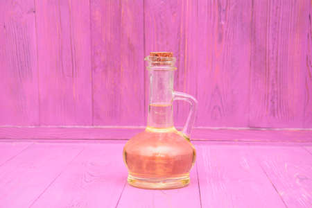 Glass bottle of fresh fragrant oil on a beautiful backgroundの写真素材