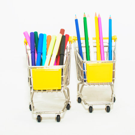 Colorful pencils in shopping cart isolated on white background, stock photo