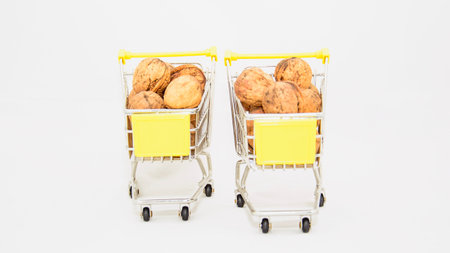 Walnuts in a shopping cart on a white background, isolated.の写真素材