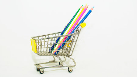 Shopping cart and colorful pencils on white background, stock photoの写真素材