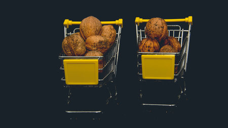 Walnuts in a shopping cart on a black background. selective focus.