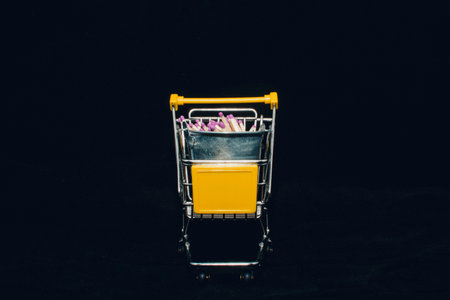 Shopping Cart with Colorful Pencils on a Black Backgroundの写真素材