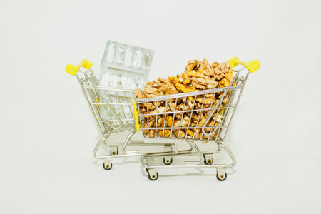 Walnuts in a shopping cart on a white background, isolate.の写真素材