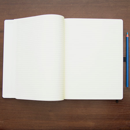 Blank open notebook with pencil on wooden table. View from aboveの写真素材