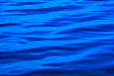 Blue water surface texture background. Abstract blue water surface with ripplesの写真素材