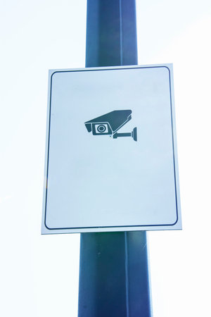 CCTV security camera on the road sign, closeup of photo