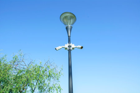 street light pole on blue sky background, closeup photo with selective focus