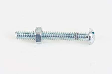 A long bolt with a nut just started on a white background.の写真素材