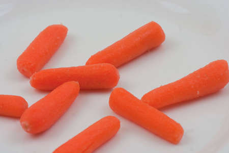Baby carrotts laid out  on a white backgroundの写真素材