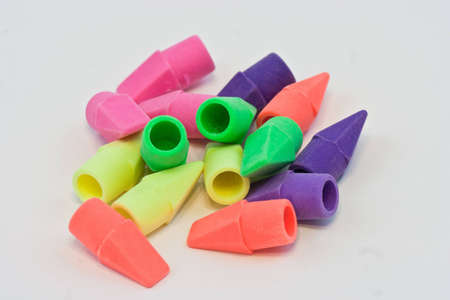 a small group of colorful erasers on a white background.の写真素材