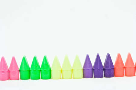 A line of colorful arranged by color group on a white background.