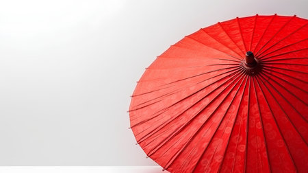 Red paper umbrella on white background with copy space for your text.の素材