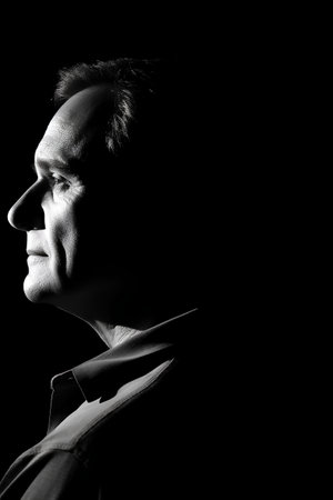 Portrait of a man on a black background. Black and white.の素材