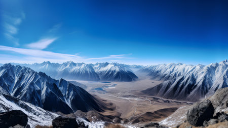 Beautiful winter mountain landscape with snow-capped peaks and blue skyの素材