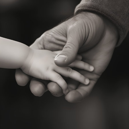 Closeup of a father holding his baby hand. Black and whiteの素材