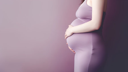 Pregnant woman in purple leggings on a purple backgroundの素材