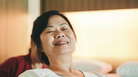 Portrait of asian woman relaxing with closed eyes at home.の素材