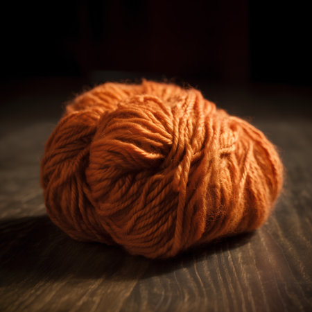 Ball of yarn for knitting on a wooden background. Shallow depth of fieldの素材