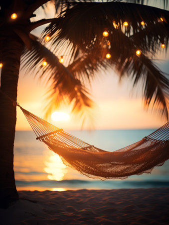Hammock on the beach with palm tree and sunset background.の素材