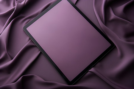 Tablet on purple satin background. 3d render illustration.の素材