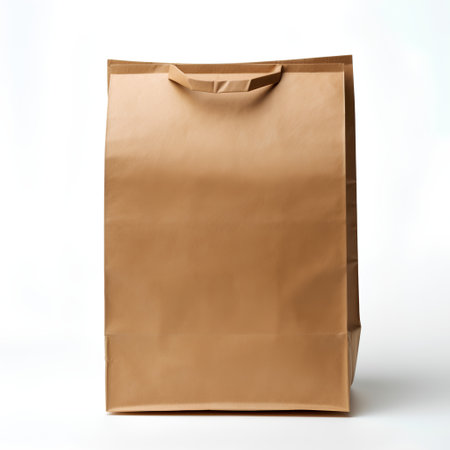 Brown paper bag isolated on white background. Clipping path included.の素材