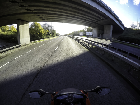 Motorcycle on the road with lights on in London, UKの写真素材