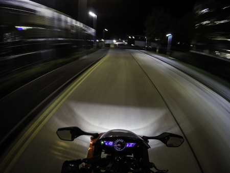 Motorcycle in motion after dark - a view from rider position / London, UKの写真素材