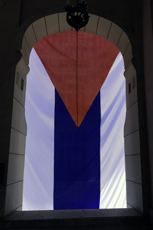 National flag of Cuba hanging in window - Havana, Cubaの写真素材