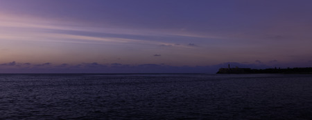 Sunset over Malecon and Atlantic Ocean with Morro Castle in background - Havana, Cubaの写真素材