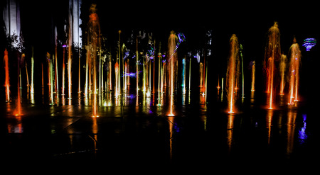 Illuminated water splash by night in  Torun, Polandの写真素材