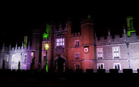 Illuminated Hampton Court Palace by night in Hampton Court, London, United Kingdomのeditorial素材