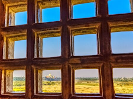 Taj Mahal behind bars - panoramic view of fields with Taj Mahal in background  from Agra Red Fort in Agra, Uttar Pradesh, Indiaの写真素材