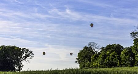 Three hot air balloons over French fields - Dinan, France