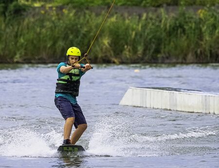 Teenager wakeboarding on a lake - Brwinow, Masovia, Polandの写真素材