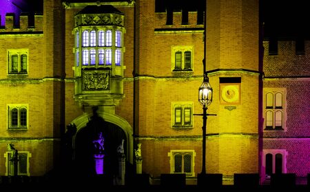 Illuminated Hampton Court Palace by night in Hampton Court, London, United Kingdom