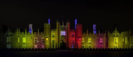 Illuminated Hampton Court Palace by night in Hampton Court, London, United Kingdom