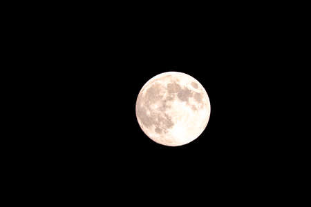 Full round moon in dark sky