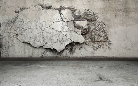 Grunge interior background with cracked wallの写真素材