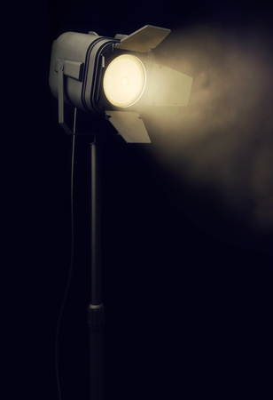 Warm stage spotlight shines in dark backgroundの写真素材