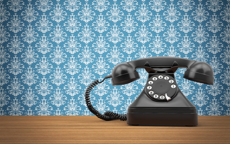 Vintage rotary phone on the wooden tableの写真素材