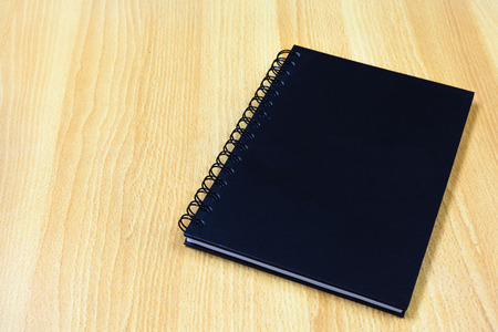 black cover notebook on wood tableの写真素材
