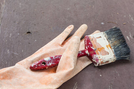 old orange glove and paint brushの写真素材
