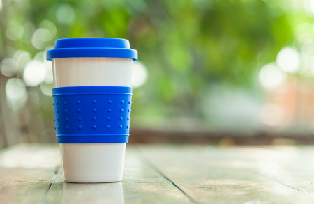 coffee cup on blur garden backgroundの写真素材