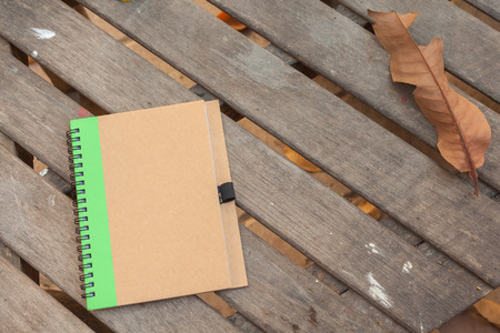 brown cover notebook on wood textureの写真素材