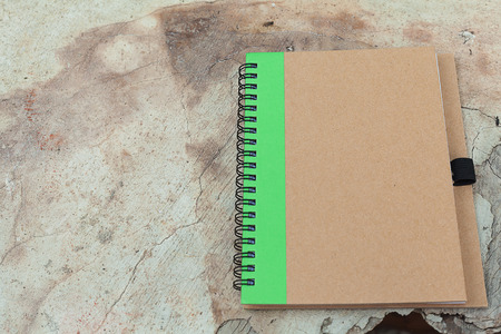 brown cover notebook on wood textureの写真素材