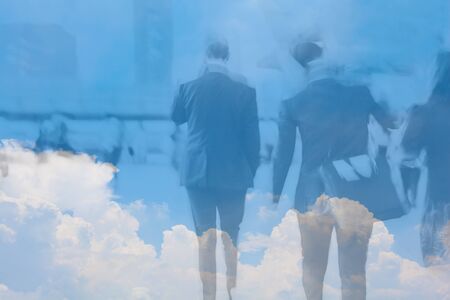 motion blur business people in cloud sky backgroundの写真素材
