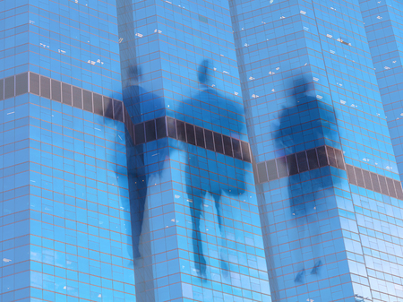 motion blur business people with modern office building background