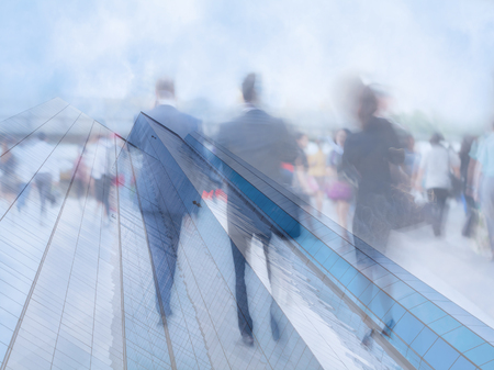 motion blur business people with modern skyscraper backgroundの写真素材